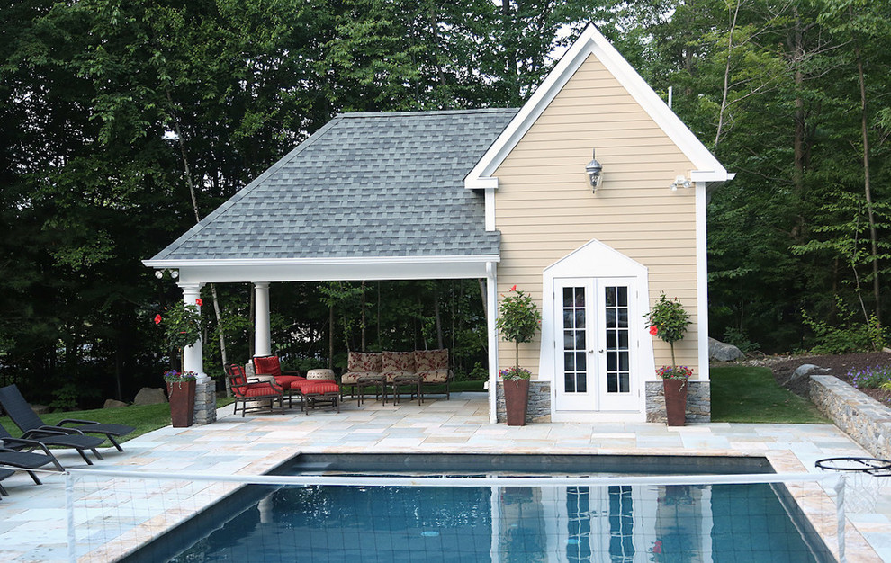 Photo of a medium sized classic back rectangular lengths swimming pool in Bridgeport with a pool house and natural stone paving.