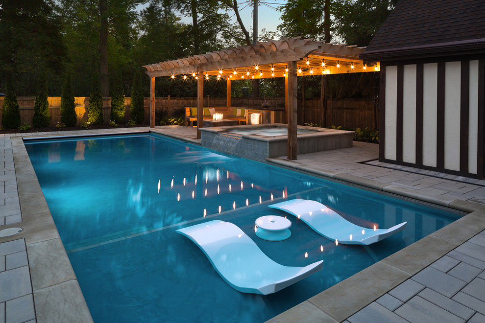 Hot tub - traditional backyard rectangular and concrete paver hot tub idea in Cleveland