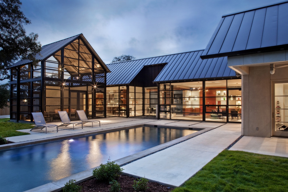 Trendy stamped concrete and rectangular pool photo in Other