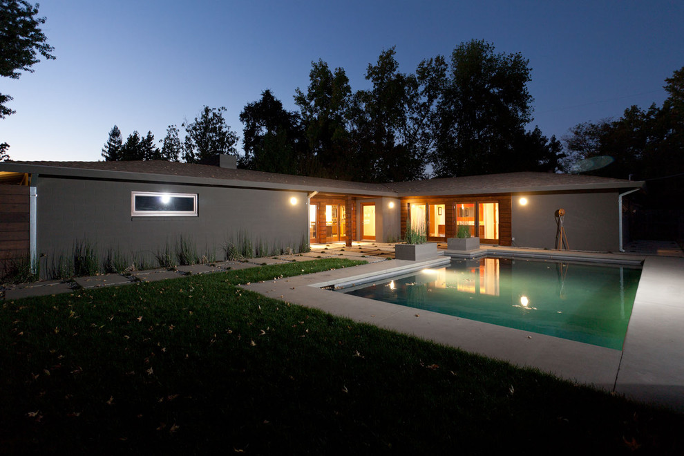 Design ideas for a medium sized modern front rectangular lengths swimming pool in Sacramento with concrete paving.