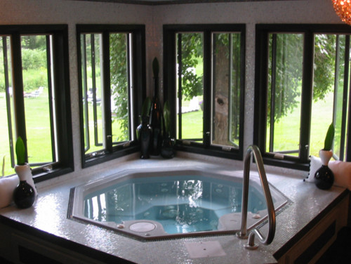 This is an example of a small contemporary indoor custom shaped hot tub in New York with tiled flooring.