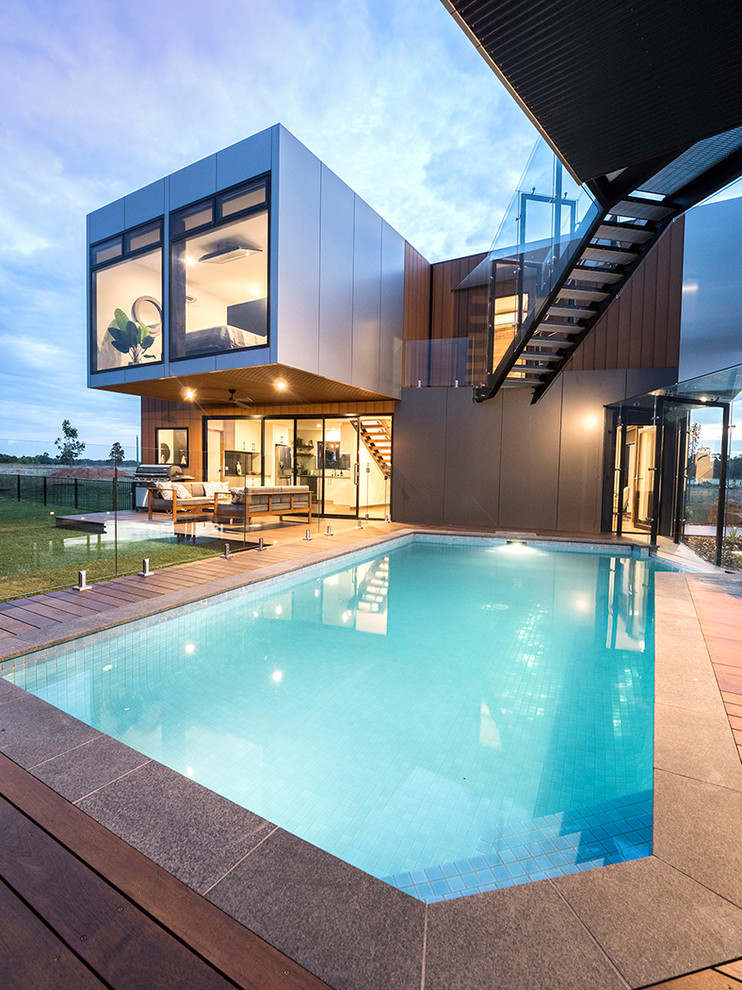 Photo of a contemporary back rectangular swimming pool in Other with decking.