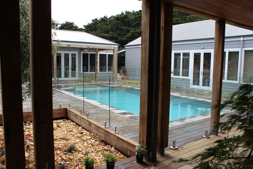 Example of a large eclectic courtyard rectangular natural hot tub design in Melbourne with decking
