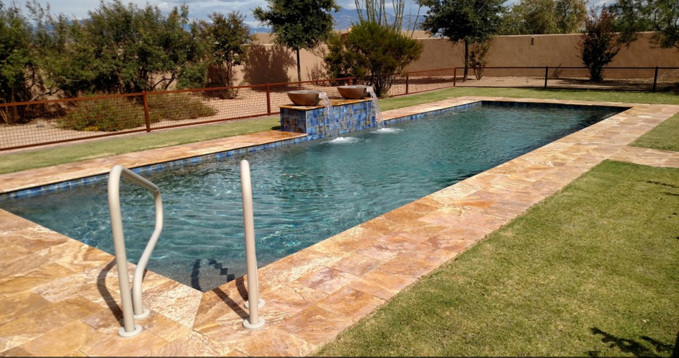 Foto di una grande piscina monocorsia contemporanea rettangolare dietro casa con fontane e pavimentazioni in cemento
