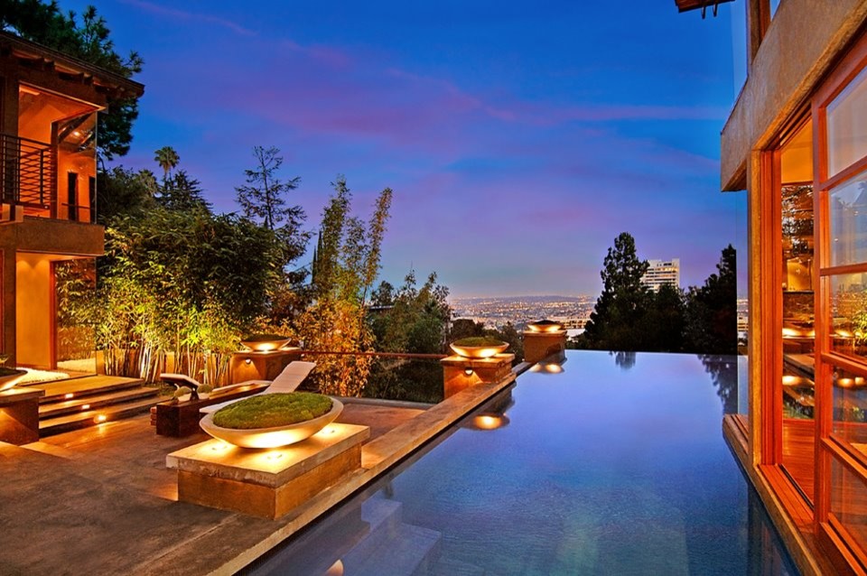 Diseño de piscina infinita asiática extra grande rectangular en patio con paisajismo de piscina