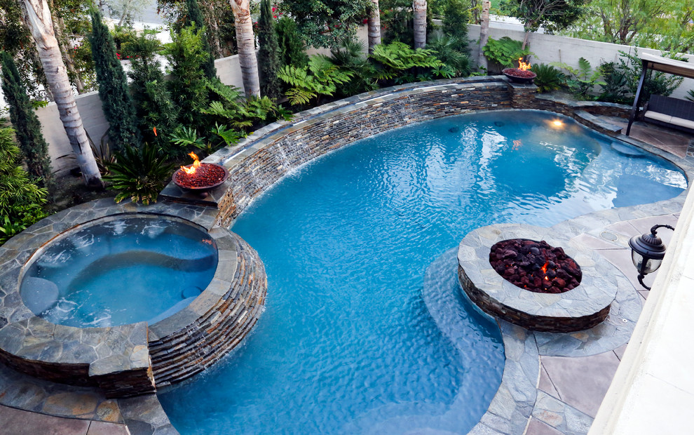 Medium sized traditional back kidney-shaped lengths hot tub in Orange County with concrete slabs.