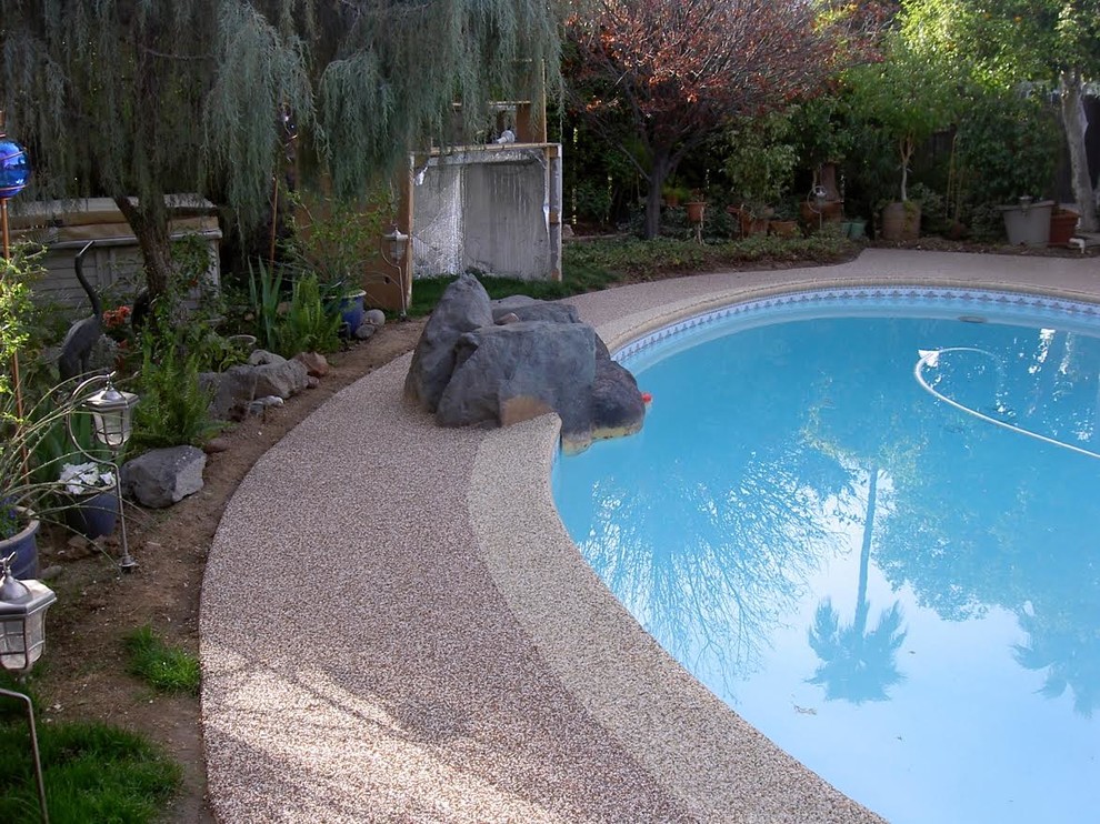 Inspiration for a medium sized traditional back kidney-shaped swimming pool in Phoenix with natural stone paving.