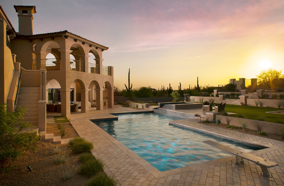 Example of a large trendy backyard custom-shaped natural pool design in Phoenix