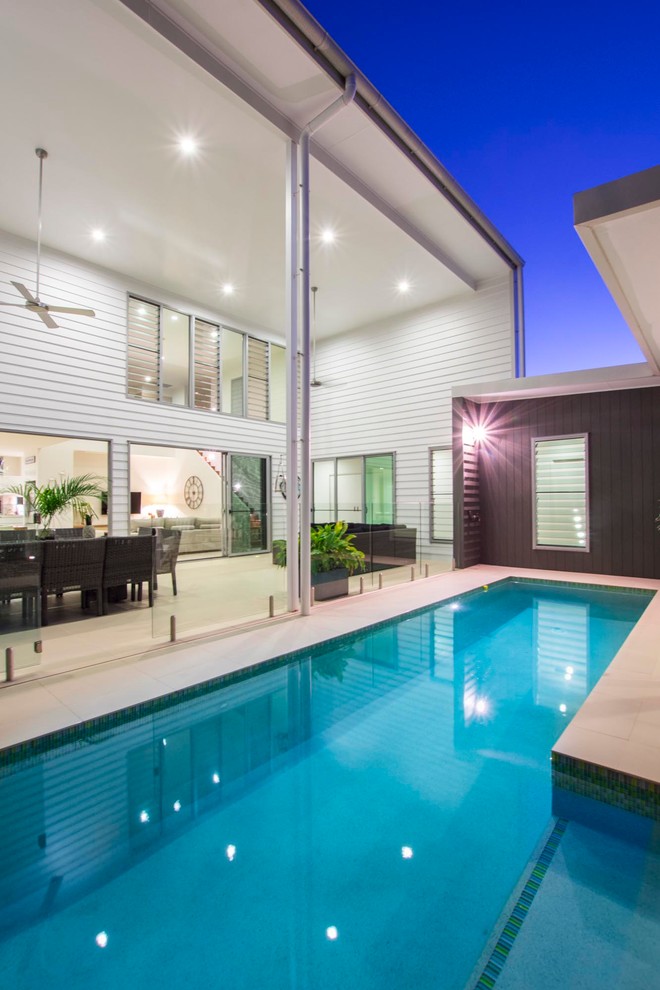 Photo of a medium sized contemporary back l-shaped swimming pool in Brisbane with tiled flooring.
