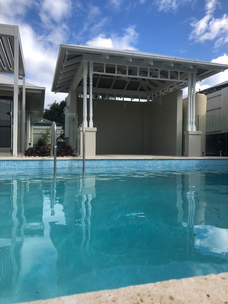 Foto de casa de la piscina y piscina natural marinera grande rectangular en patio trasero con adoquines de piedra natural