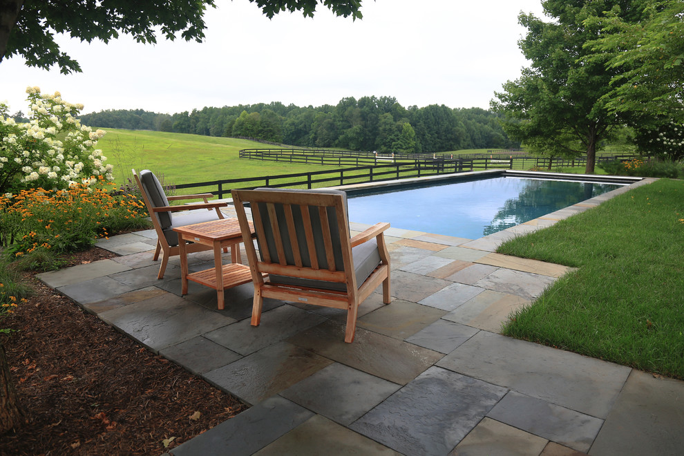 Immagine di una piscina monocorsia country rettangolare dietro casa con piastrelle