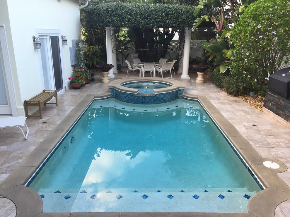 Example of a mid-sized tuscan backyard tile and custom-shaped hot tub design in Tampa