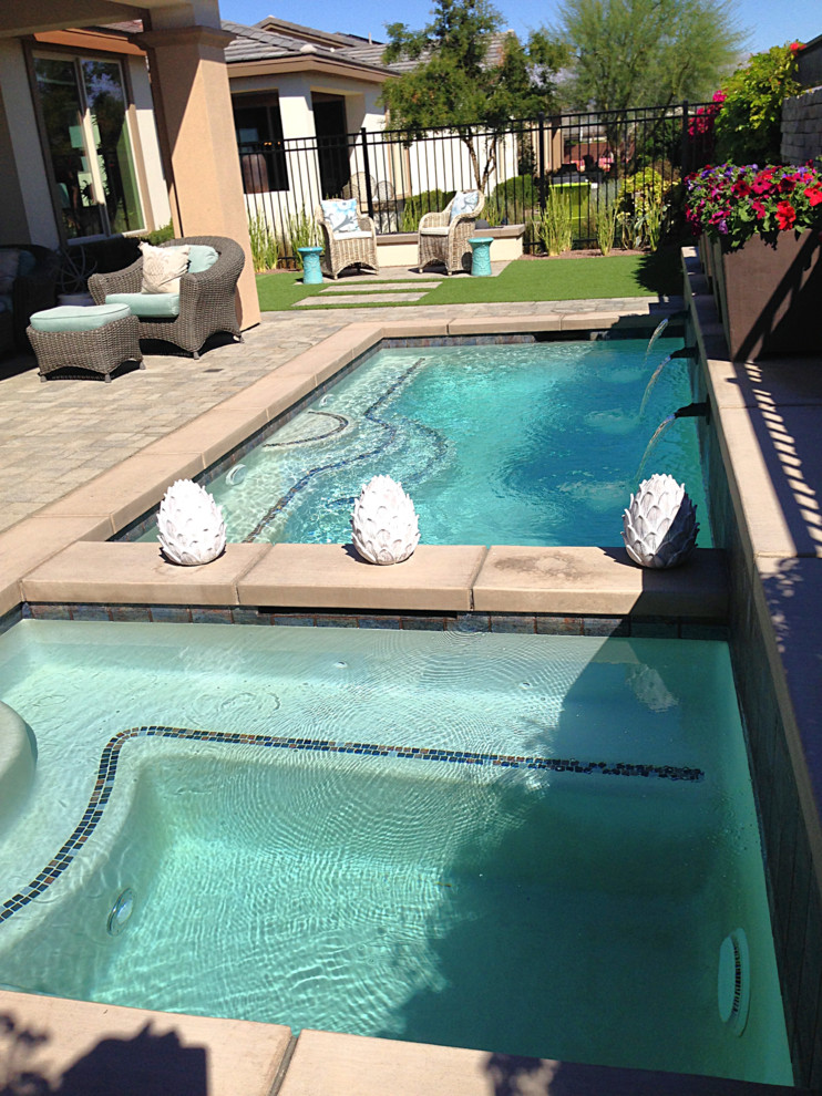 Inspiration for a small contemporary backyard custom-shaped and concrete paver lap hot tub remodel in Phoenix