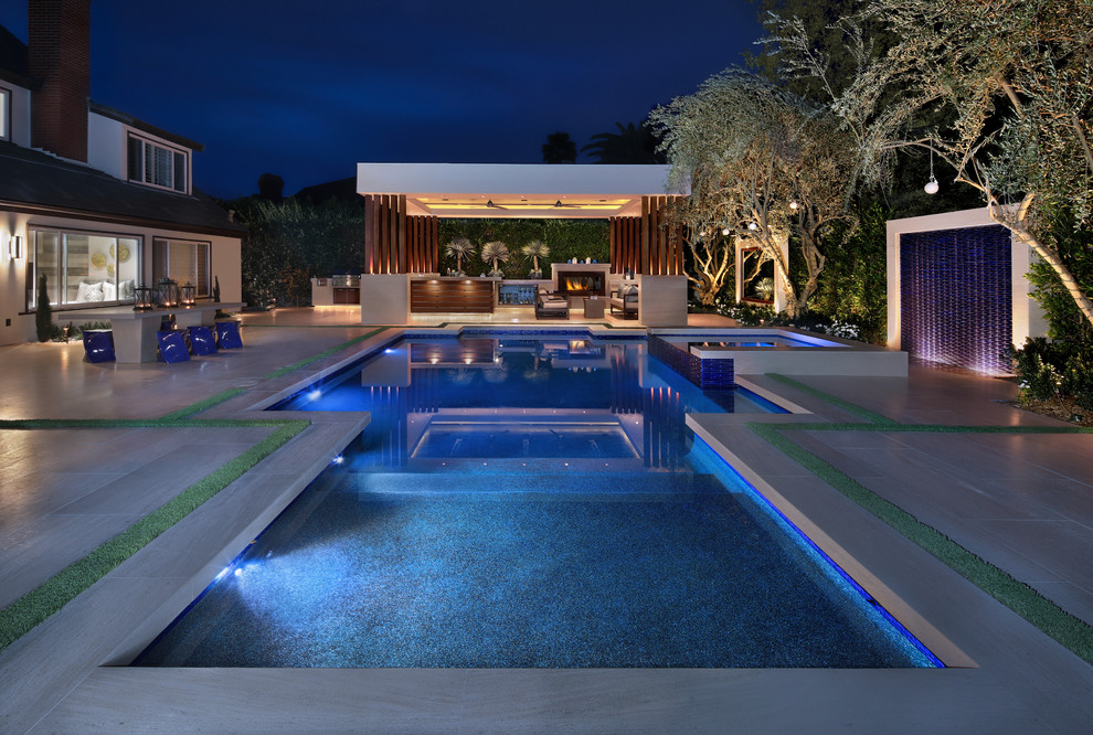 Großer Moderner Pool hinter dem Haus in rechteckiger Form mit Natursteinplatten in Orange County