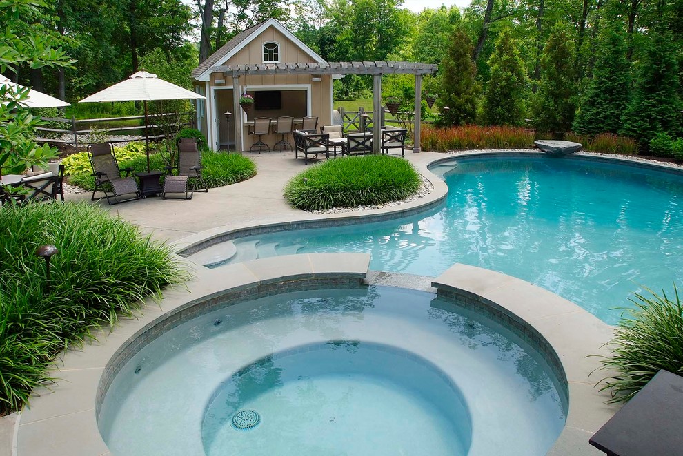 This is an example of a classic custom shaped swimming pool in Philadelphia with a bar area.