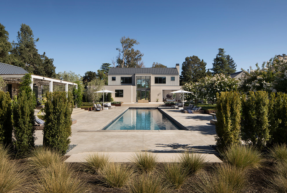Imagen de casa de la piscina y piscina de estilo de casa de campo rectangular en patio trasero