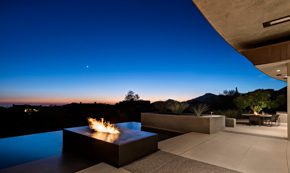 Inspiration for a mid-sized modern backyard concrete paver and rectangular infinity pool remodel in Phoenix