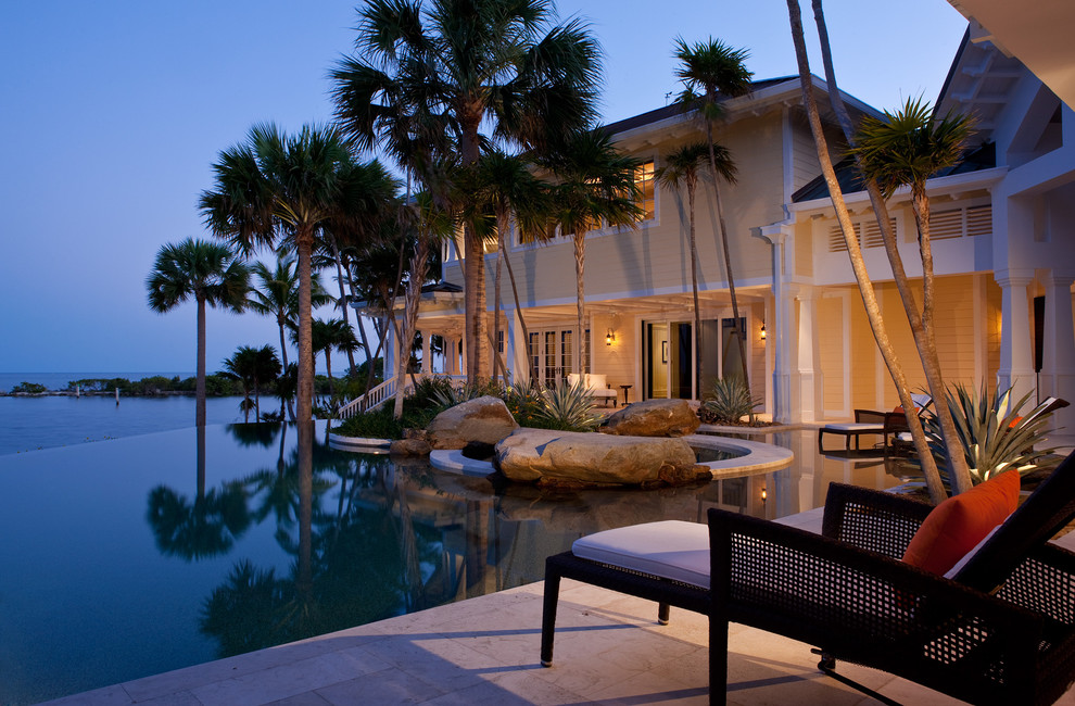 Inspiration for a world-inspired back custom shaped infinity swimming pool in Miami.
