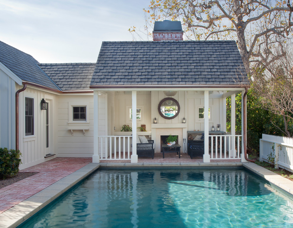 Design ideas for a nautical back rectangular swimming pool in Los Angeles with brick paving and fencing.