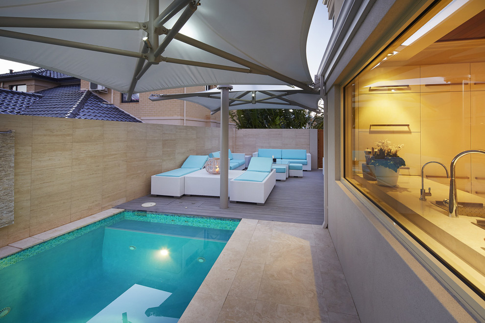 Example of a small island style pool design in Perth with decking