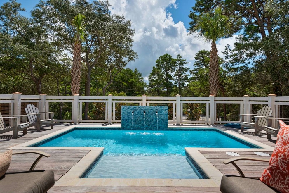Foto di una piscina costiera personalizzata di medie dimensioni e dietro casa con fontane e pedane