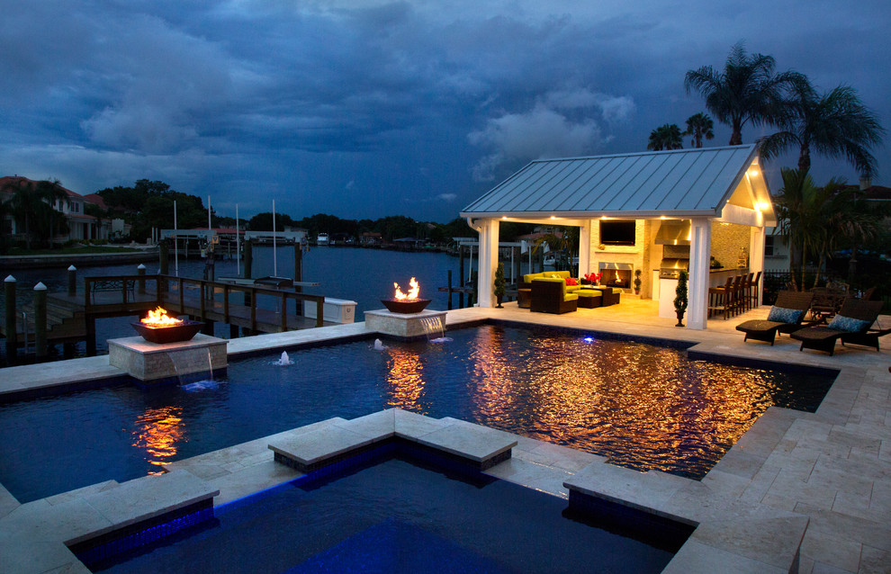 Photo of a traditional l-shaped swimming pool in Tampa with a bar area.