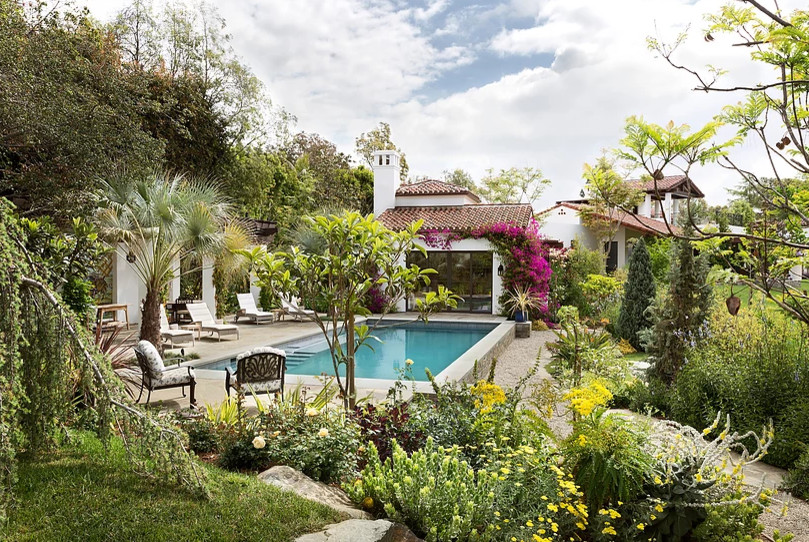 Pool house - large mediterranean backyard rectangular lap pool house idea in Los Angeles