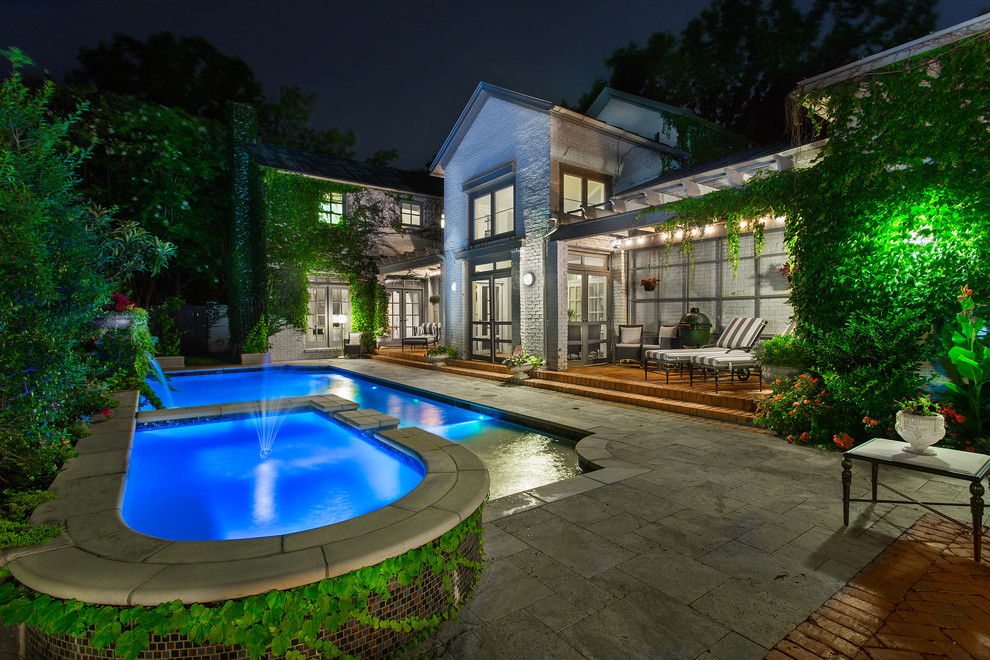 Medium sized victorian back rectangular lengths swimming pool in Dallas with a water feature and natural stone paving.