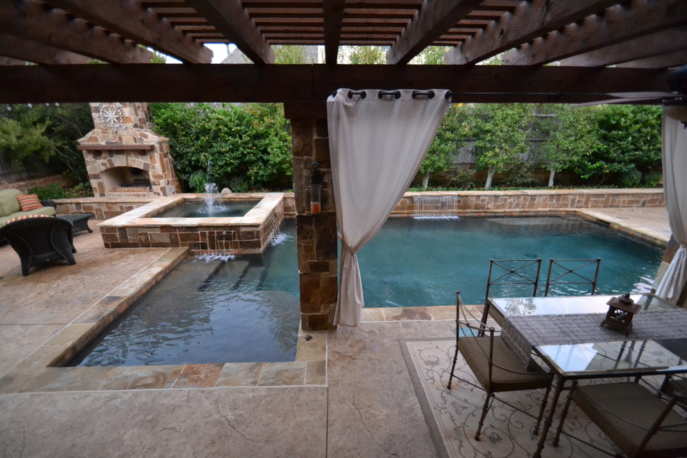 Design ideas for a small classic back custom shaped swimming pool in Dallas with a water feature and stamped concrete.