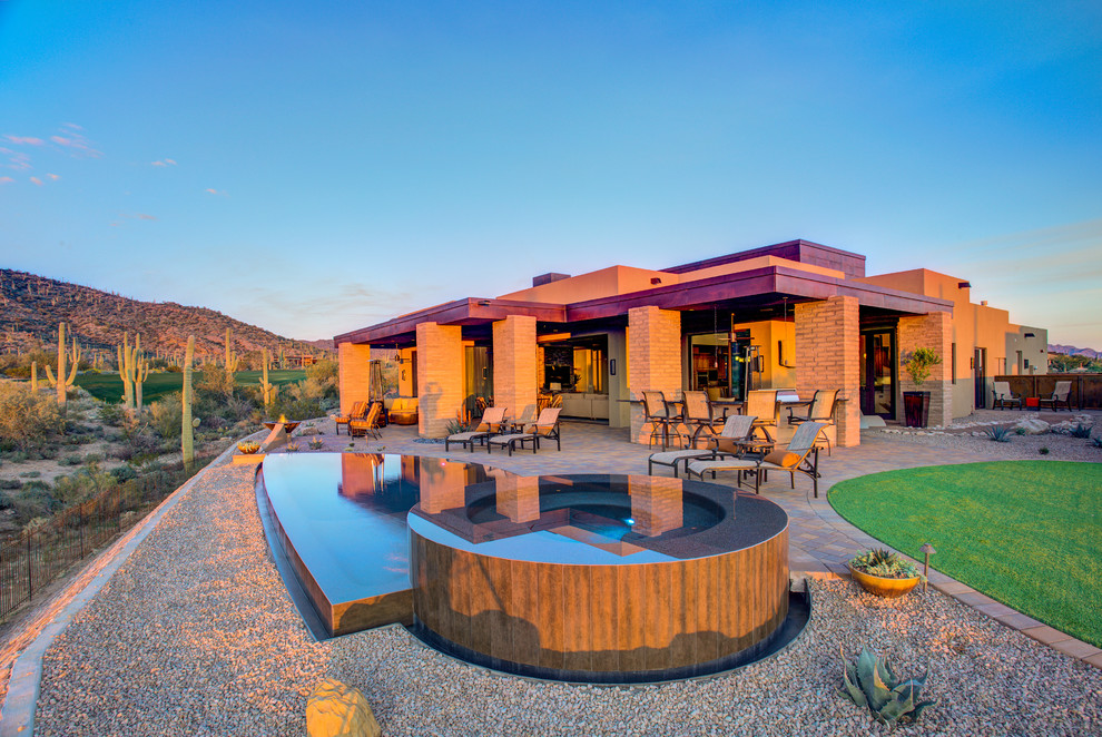 Example of a small trendy backyard custom-shaped infinity pool design in Phoenix