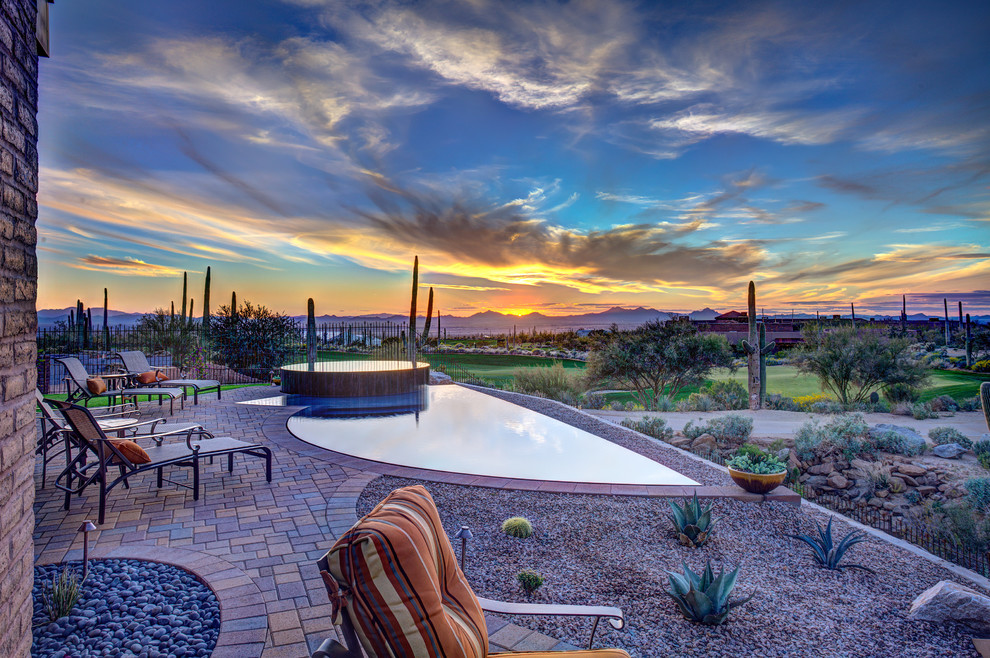 Photo of a small contemporary back custom shaped infinity swimming pool in Phoenix with with pool landscaping.