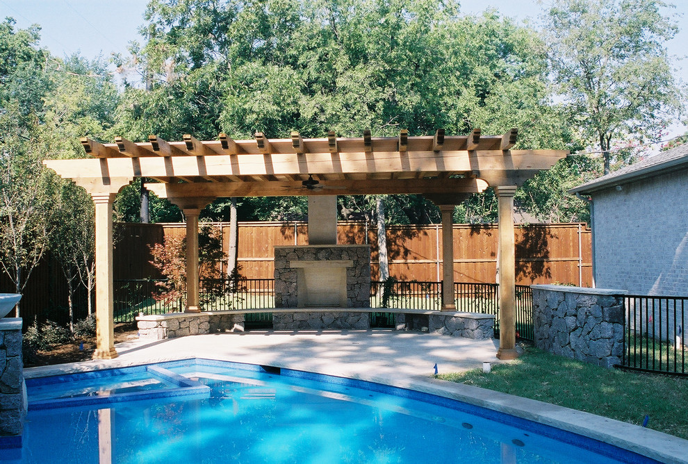 Inspiration for a large traditional back swimming pool in Dallas with tiled flooring.