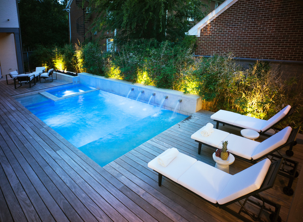 Photo of a small traditional back rectangular swimming pool in Dallas with a water feature and decking.