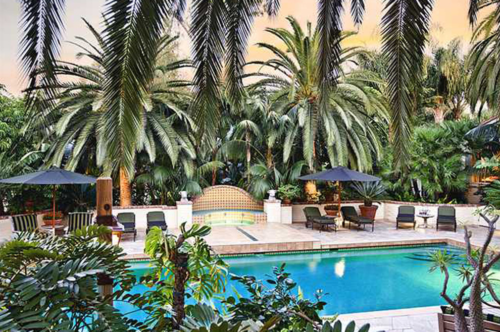Hot tub - large tropical backyard stone and rectangular lap hot tub idea in San Diego