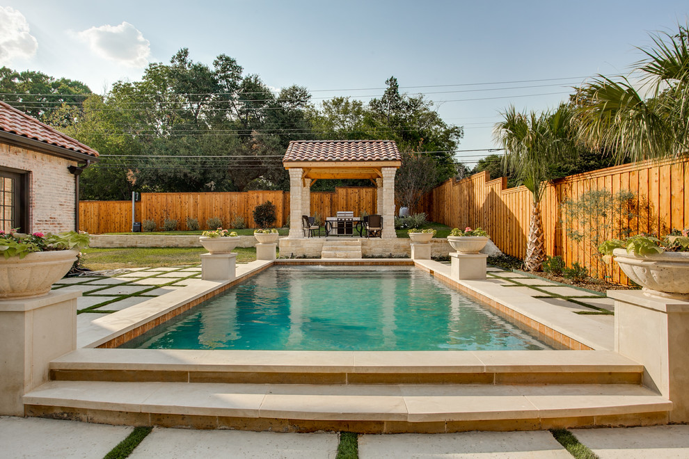 This is an example of a mediterranean back rectangular swimming pool in Austin.