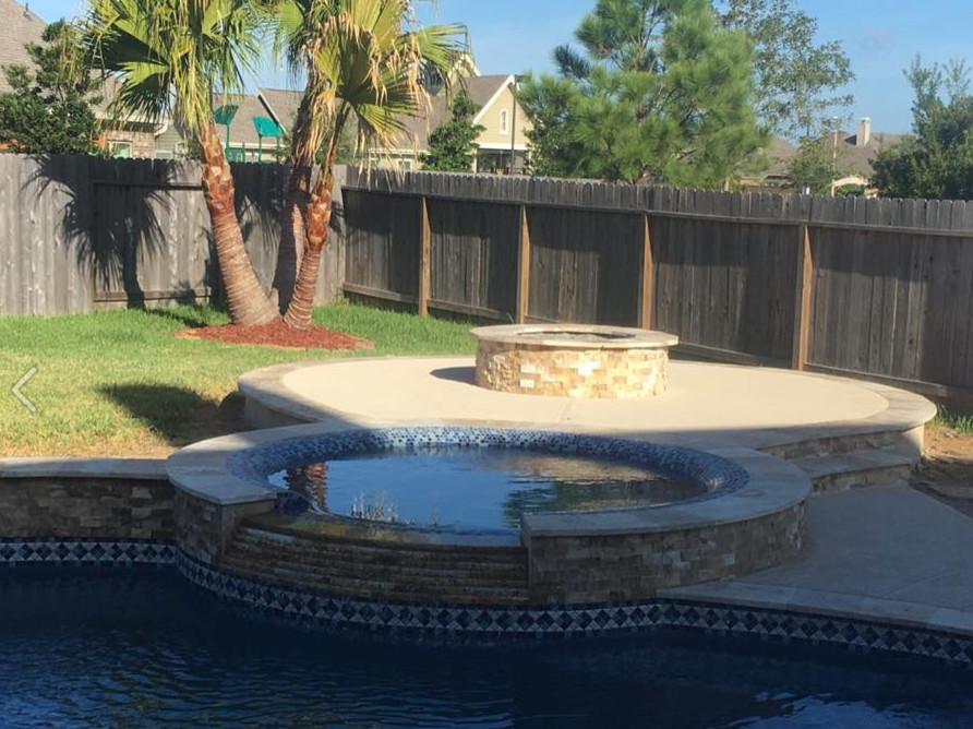 Example of a mid-sized island style backyard concrete and custom-shaped natural hot tub design in Orange County