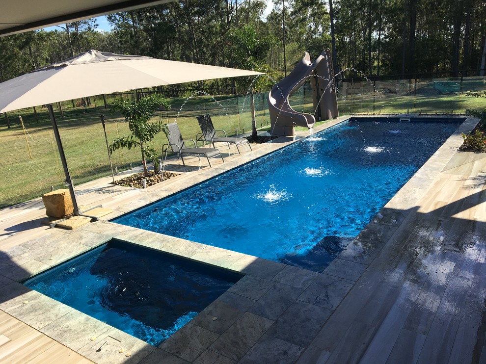 Photo of a large contemporary back rectangular swimming pool in Brisbane.