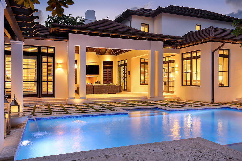 Inspiration for a mid-sized tropical backyard concrete paver and rectangular lap pool remodel in Tampa
