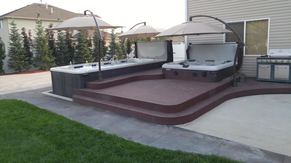 Hot tub - large traditional backyard rectangular aboveground hot tub idea in Salt Lake City with decking