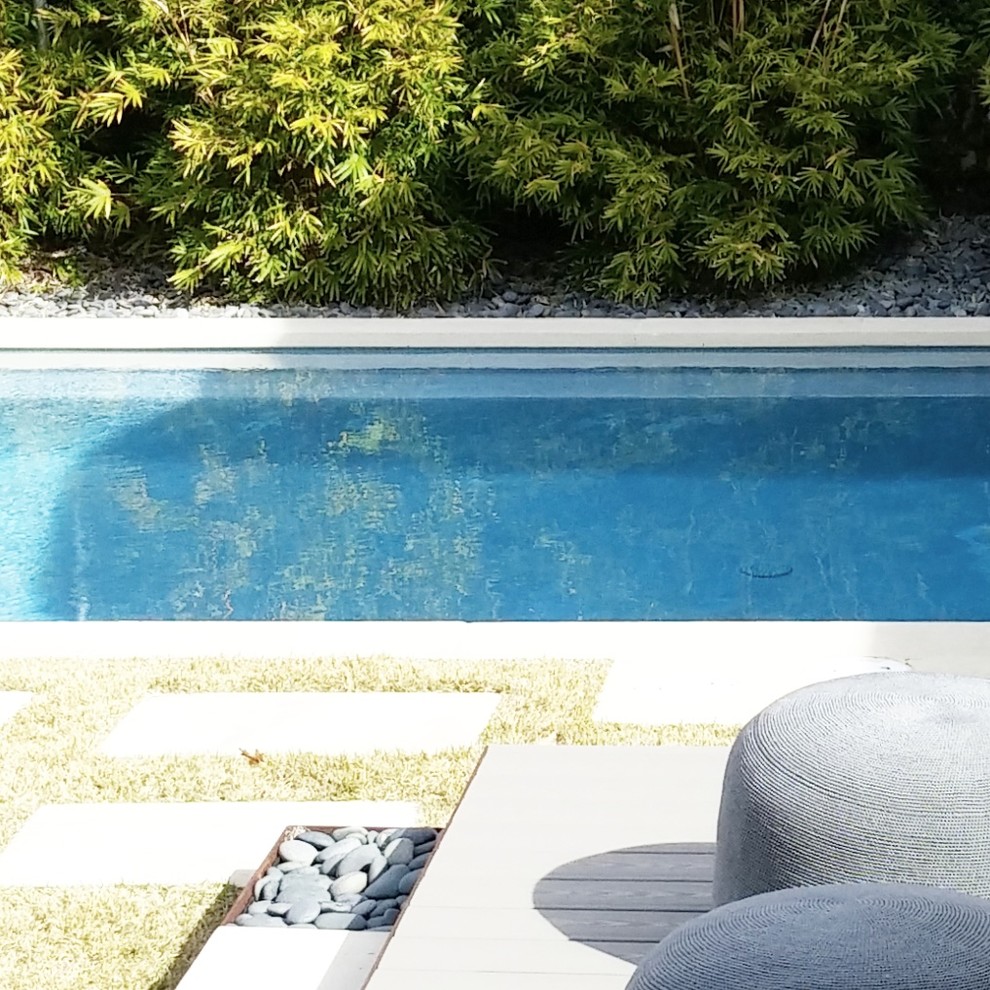 Idee per una piscina a sfioro infinito country rettangolare di medie dimensioni e dietro casa con lastre di cemento