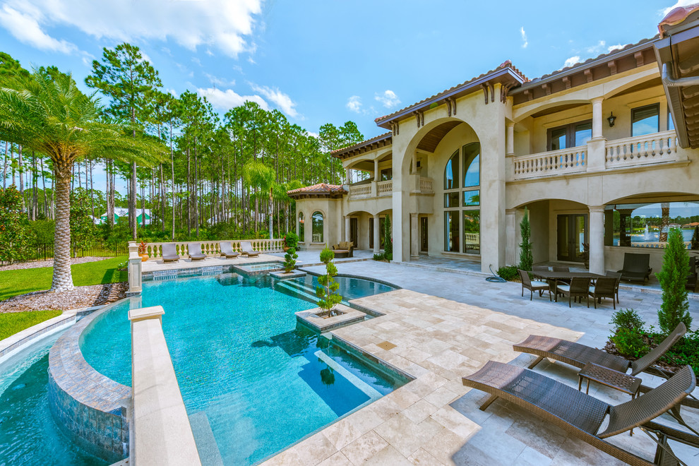 Photo of a mediterranean back custom shaped swimming pool in Jacksonville with a water feature.