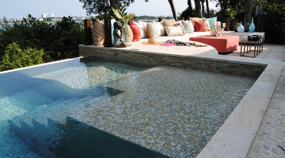 Hot tub - mid-sized eclectic backyard stone and custom-shaped infinity hot tub idea in San Diego