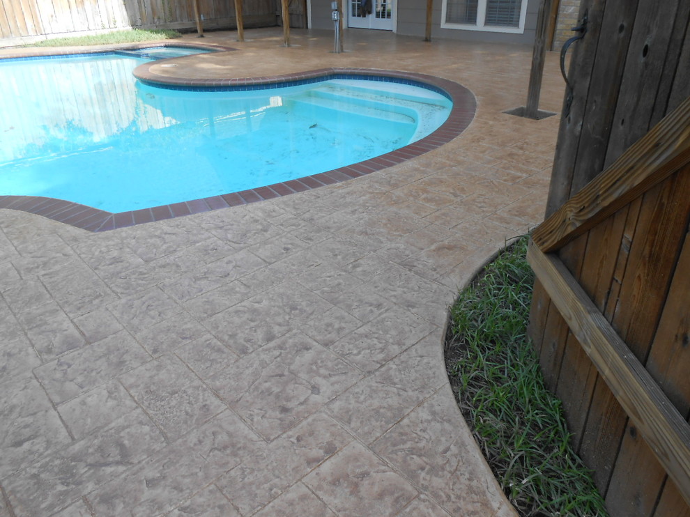 Mid-sized trendy backyard concrete paver and custom-shaped pool photo in Houston