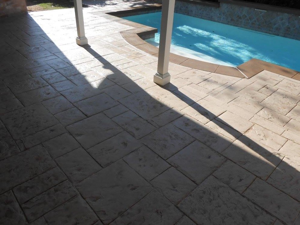 Esempio di una piscina design personalizzata di medie dimensioni e dietro casa con pavimentazioni in cemento
