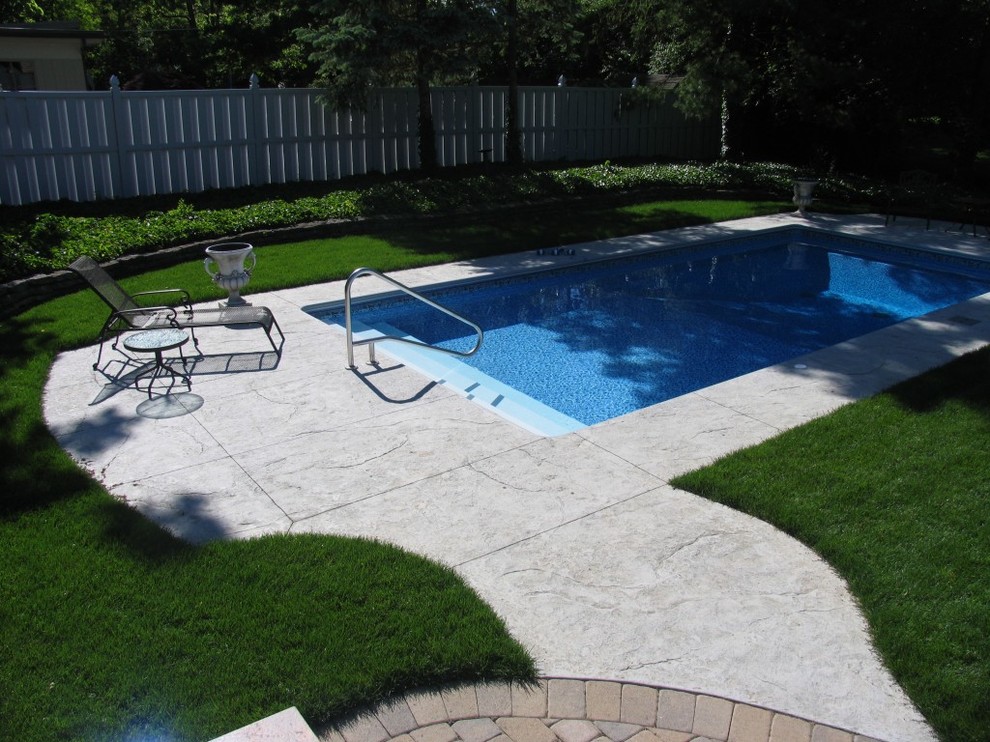 Design ideas for a medium sized classic back rectangular swimming pool in Columbus with concrete paving.