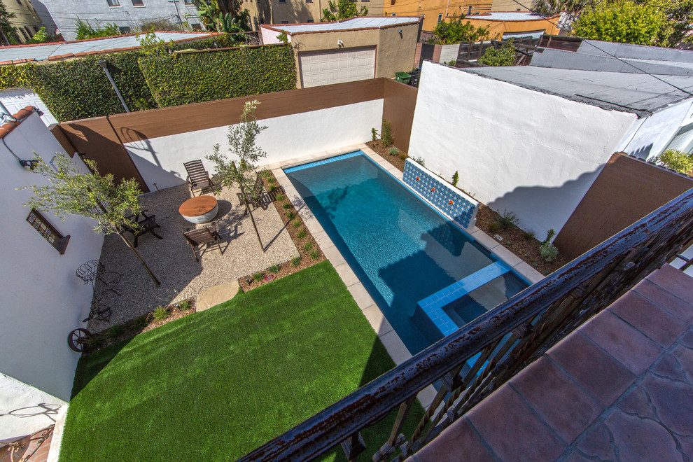 Example of a mid-sized tuscan backyard gravel pool design in Los Angeles
