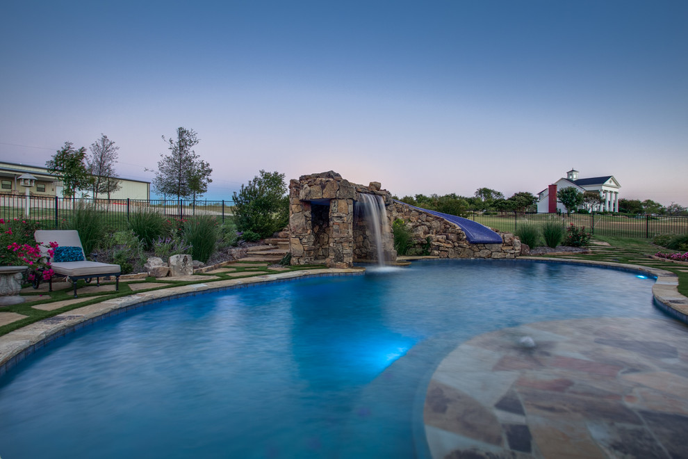 Inspiration for a rustic backyard stone and custom-shaped pool fountain remodel in Dallas