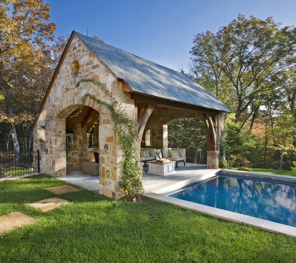 Example of a large classic backyard rectangular and stone lap pool house design in Nashville