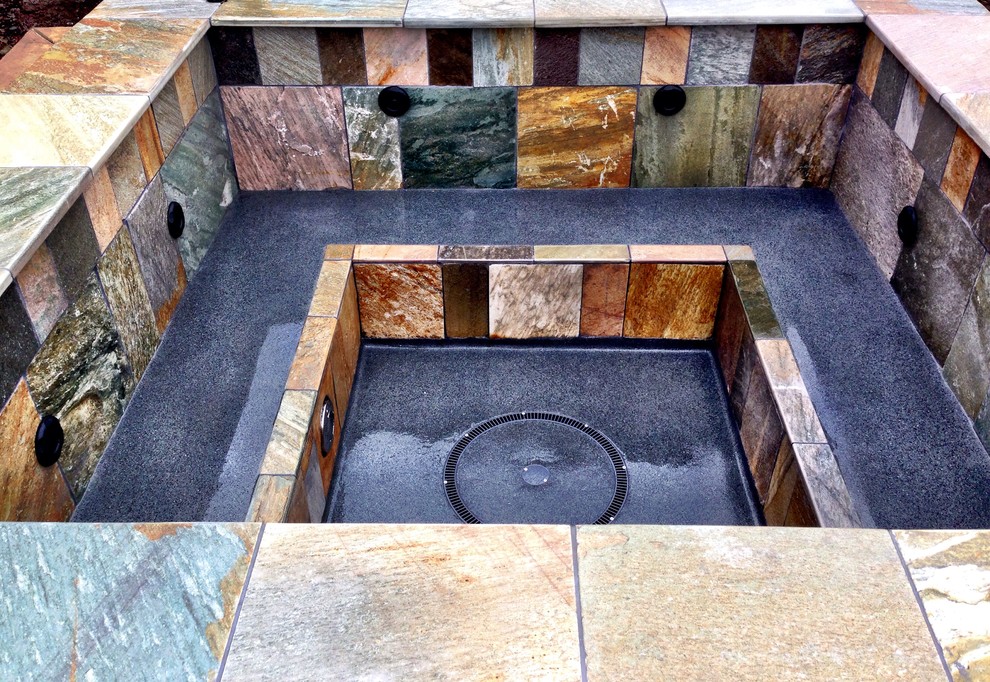 Photo of a medium sized modern back custom shaped hot tub in Portland with stamped concrete.