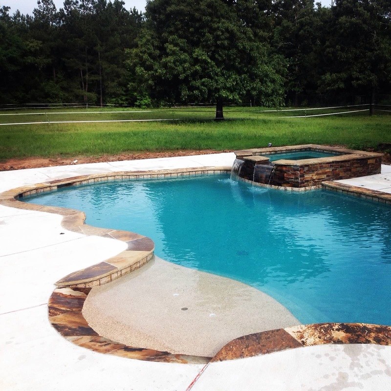 Design ideas for a large coastal back custom shaped lengths hot tub in Houston with concrete paving.